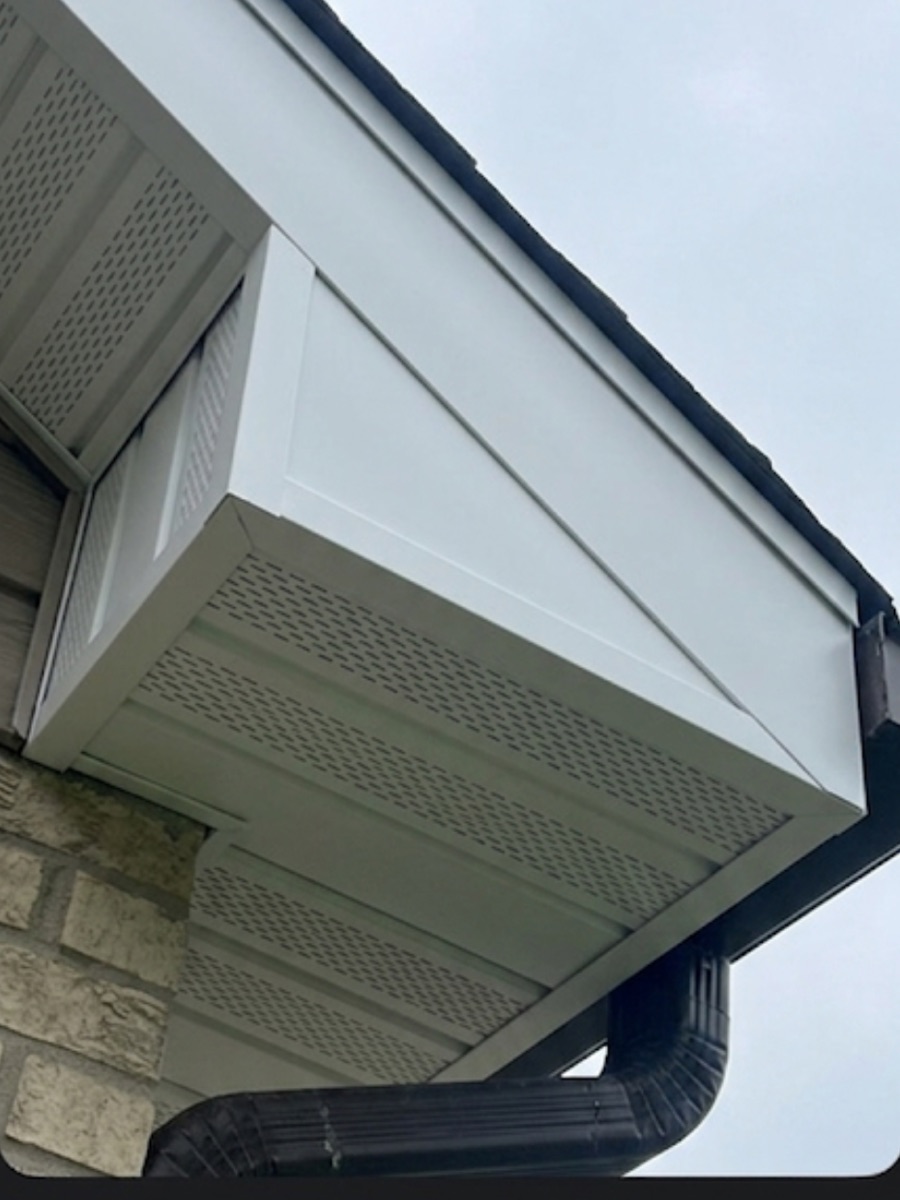 New white-wrapped fascia, vented aluminum soffit and black seamless gutter installed by GRA